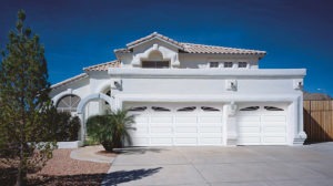 a home with a double garage door and a single garage door