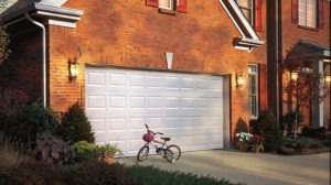 a tricycle outside a garage door