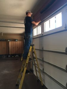 a broken garage door panel being repaired in Omaha Nebraska