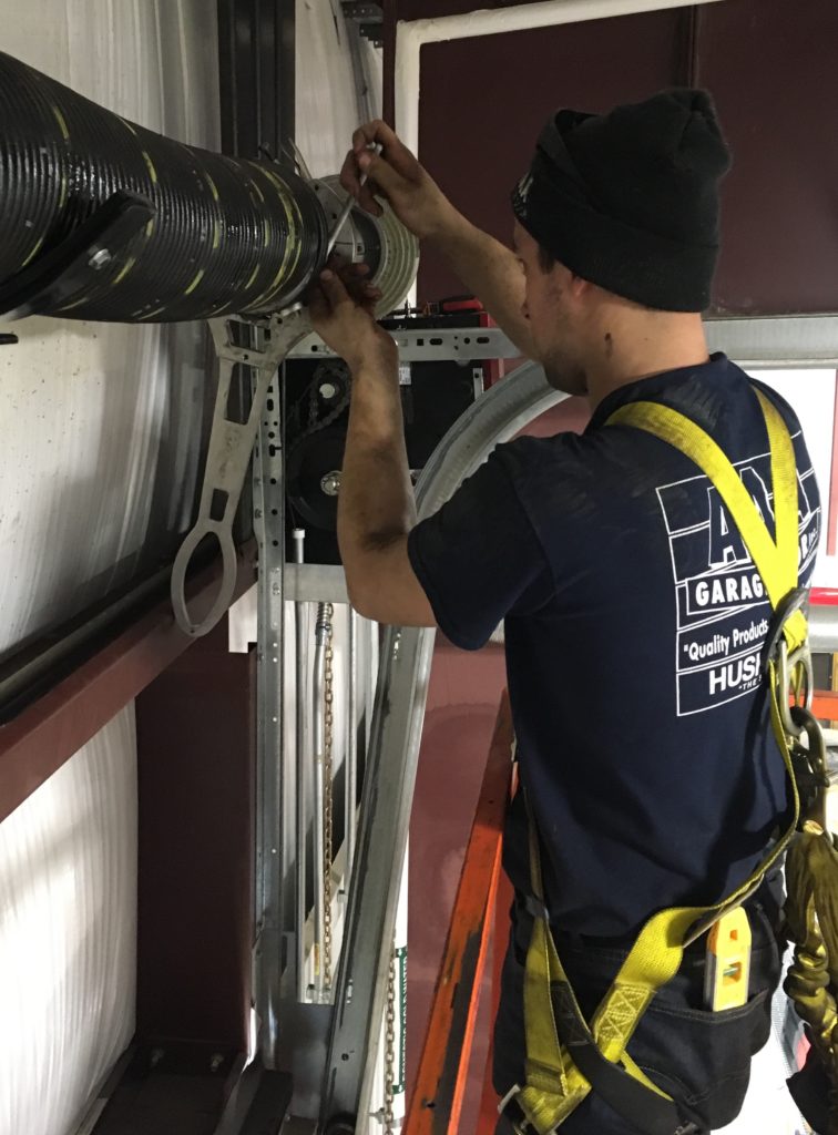 aaa garage door serviceman replacing a broken residential garage door