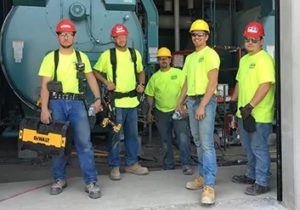 aaa garage door workers posing for a picture before going out to service broken garage door openers