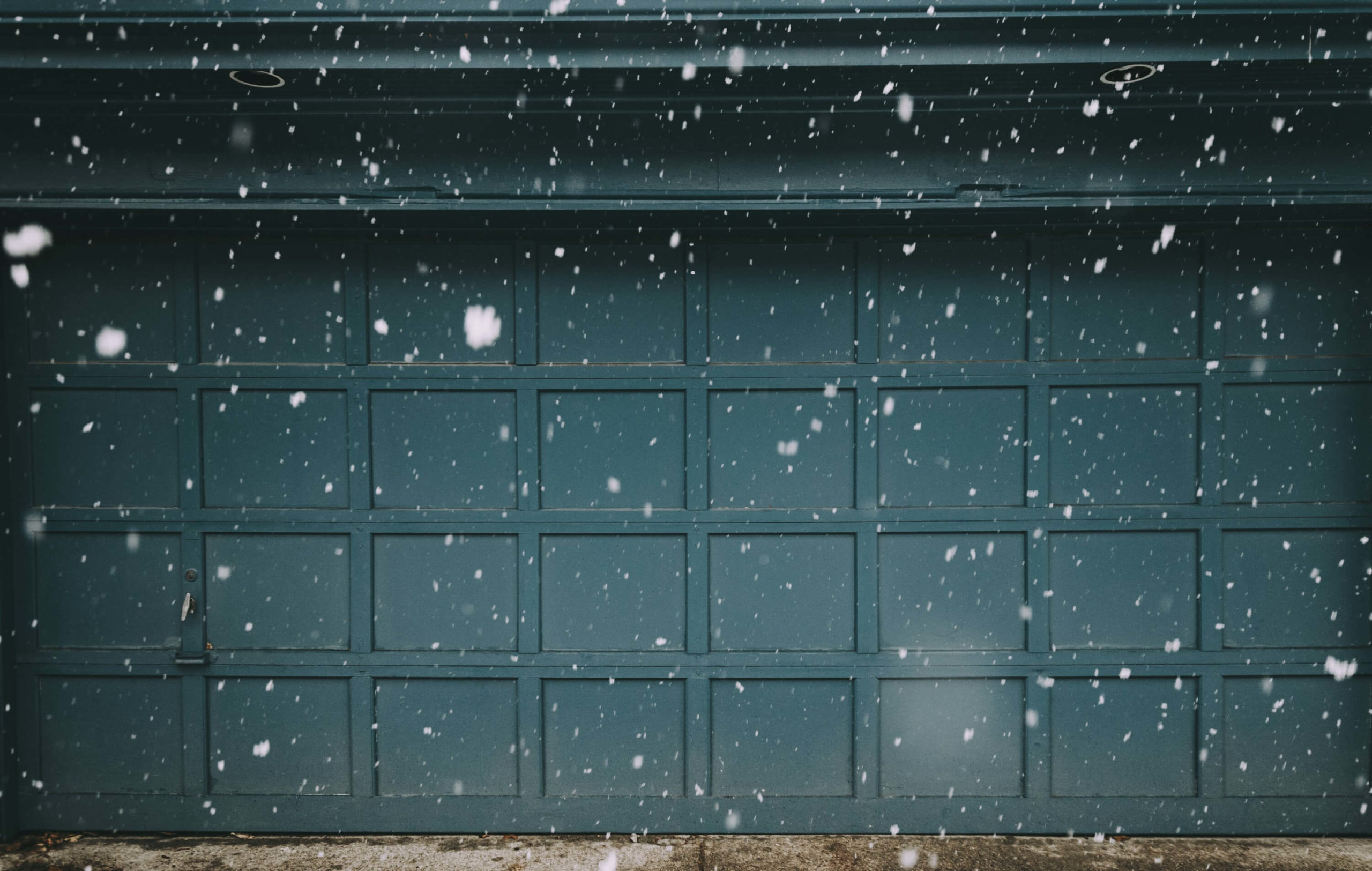 a garage door being affected by snow