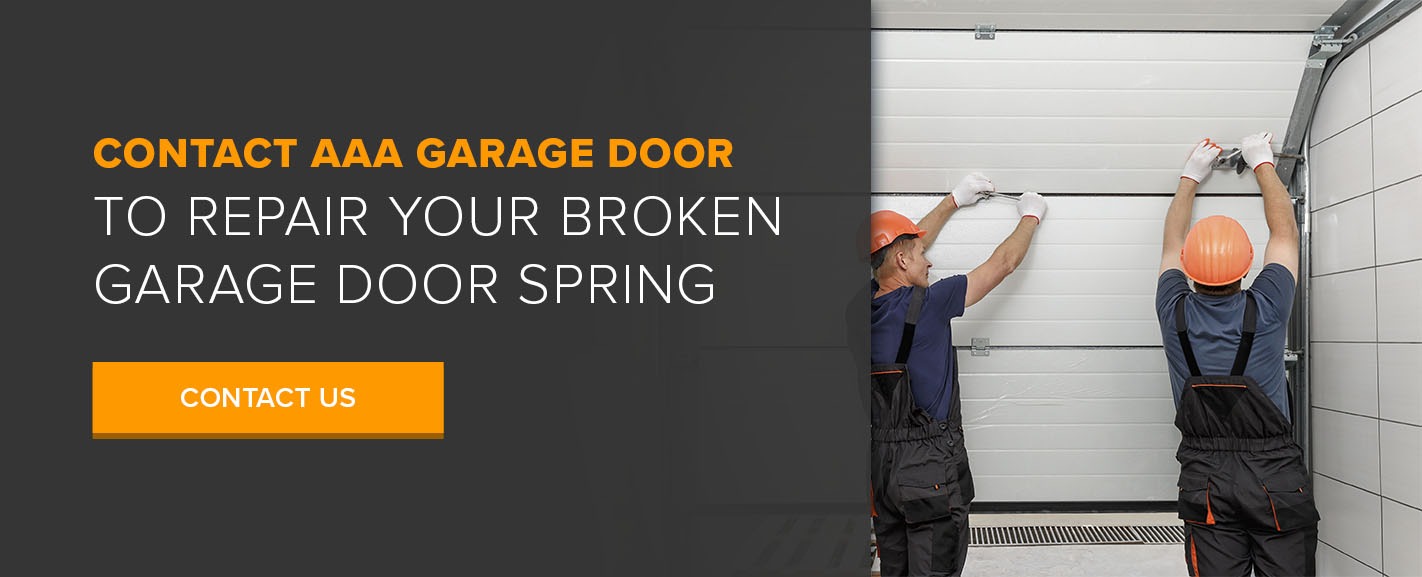 two professionals fixing a broken garage door spring