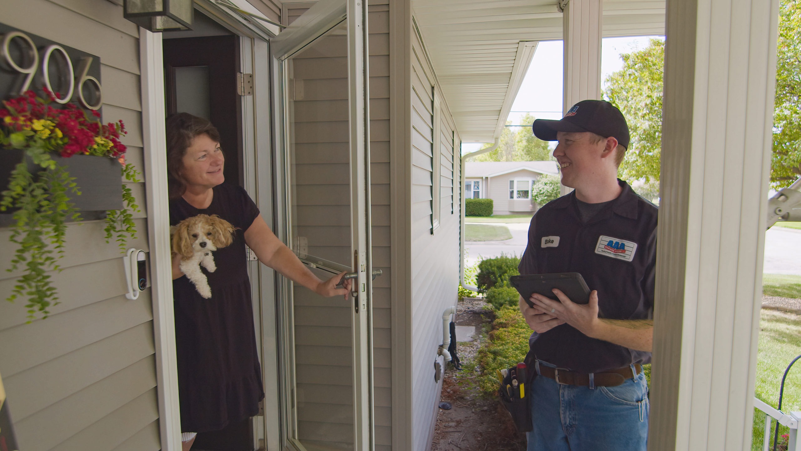 a garage door technician meeting a customer at the door