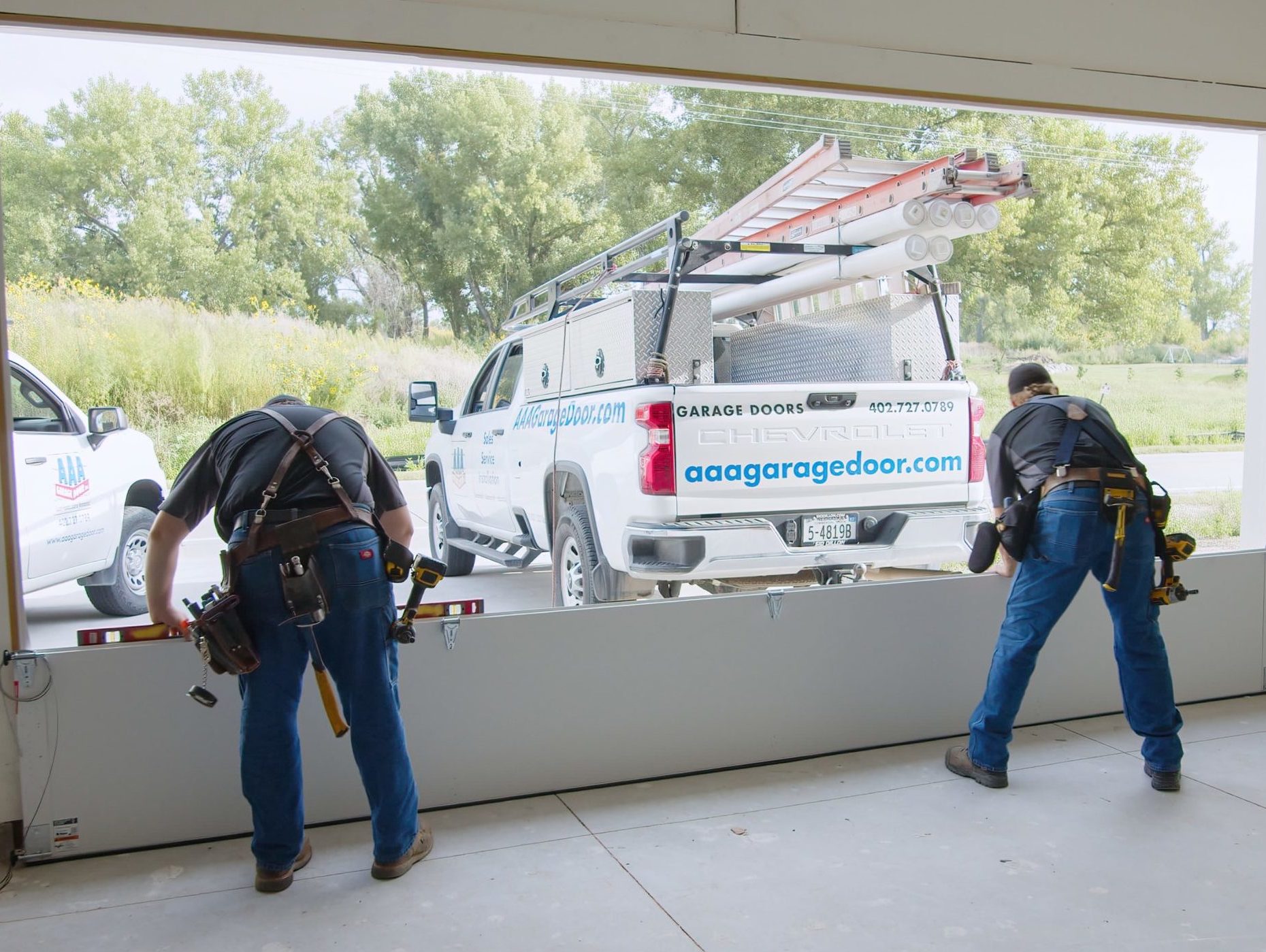 two garage door technicians installing a new garage door in omaha nebraska