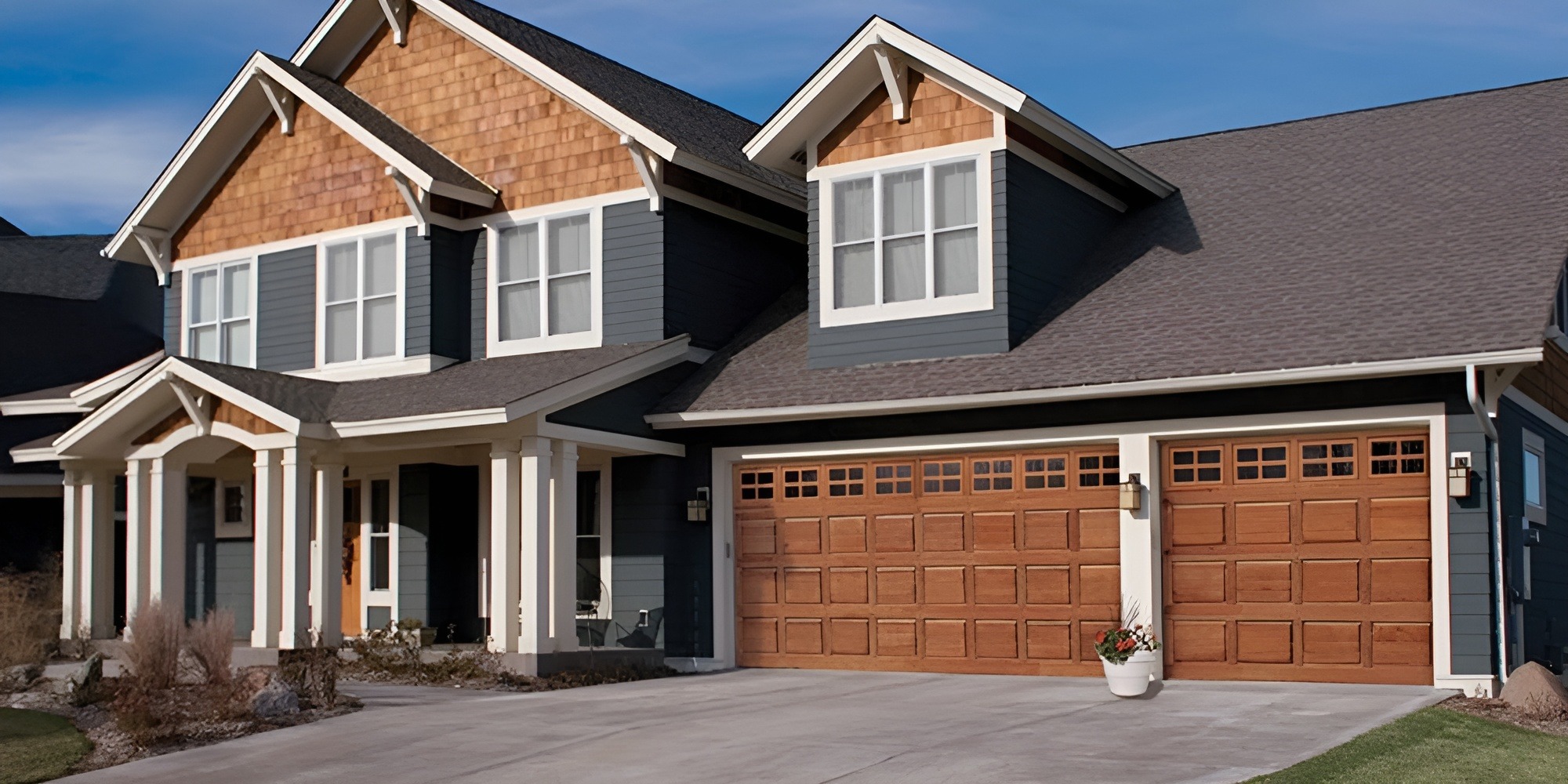 a large house with two wooden garage doors