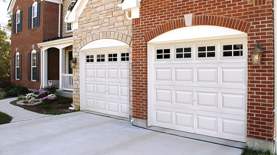a brick house with a white garage door