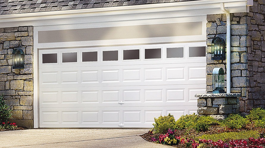 a white garage door with a stone wall behind it