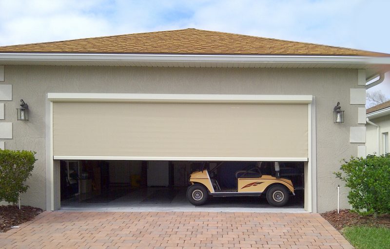 a beige garage door is partially open