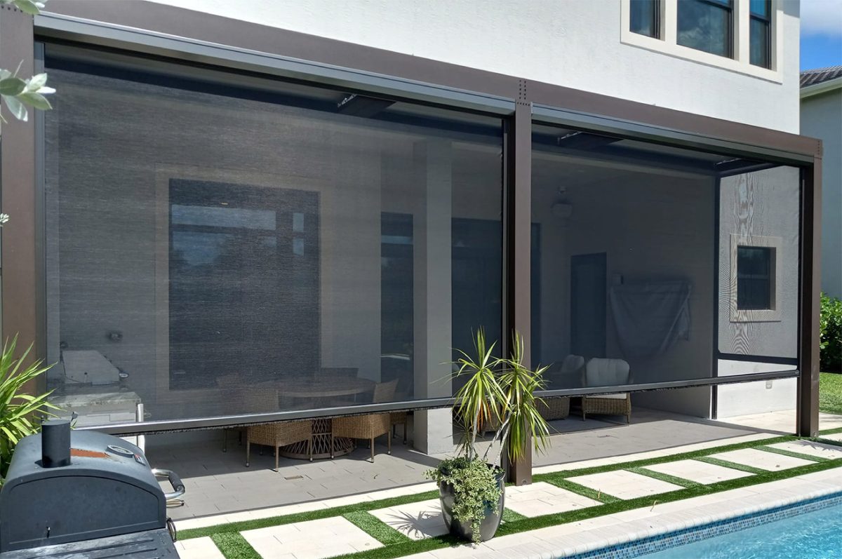 a patio with a screened in porch and a swimming pool