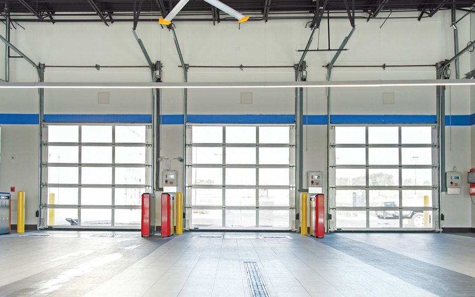 the inside of a garage with a three aluminum garage doors