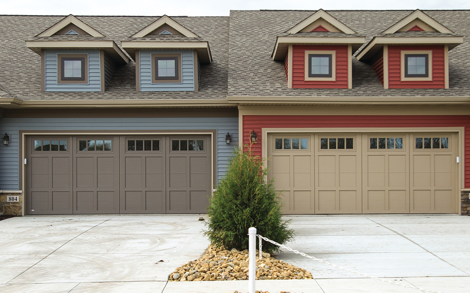 two houses with brown garage doors side by side