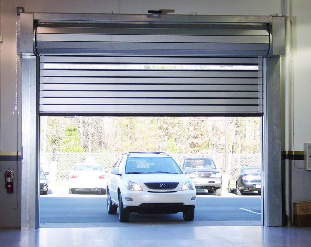 Lexus-vehicle-driving-through-open-dealership-bay-door